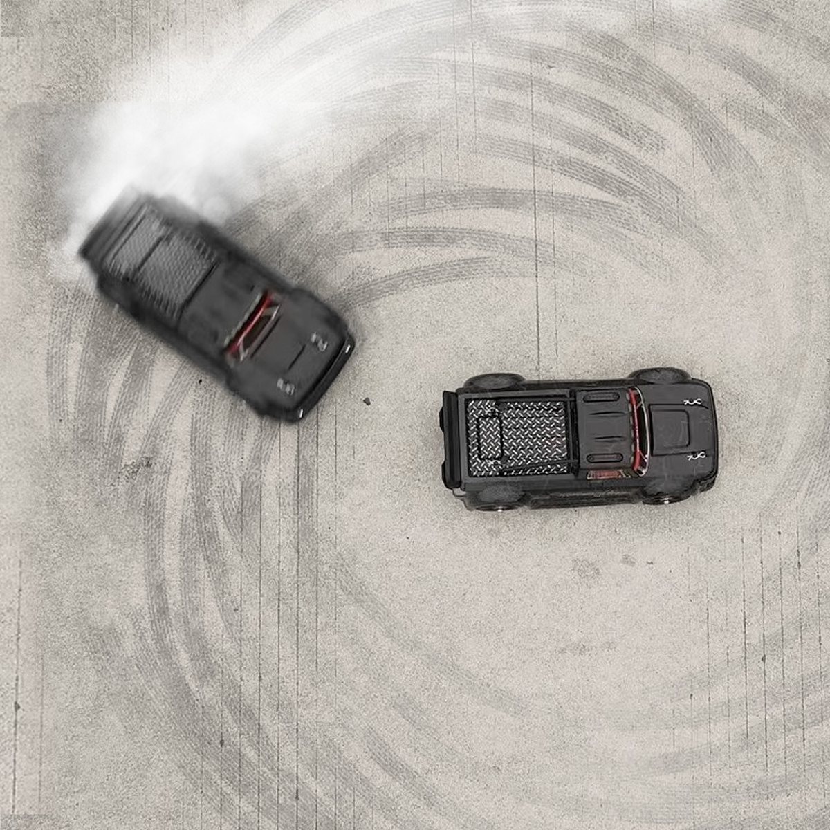 Two HYPER GO RC trucks on sand